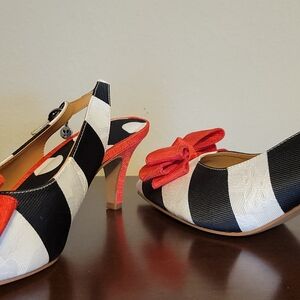 Stylish Black and White Heels with Red Accents